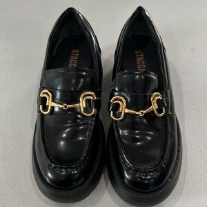 Staccato Glossy Black Loafers with Gold Buckles